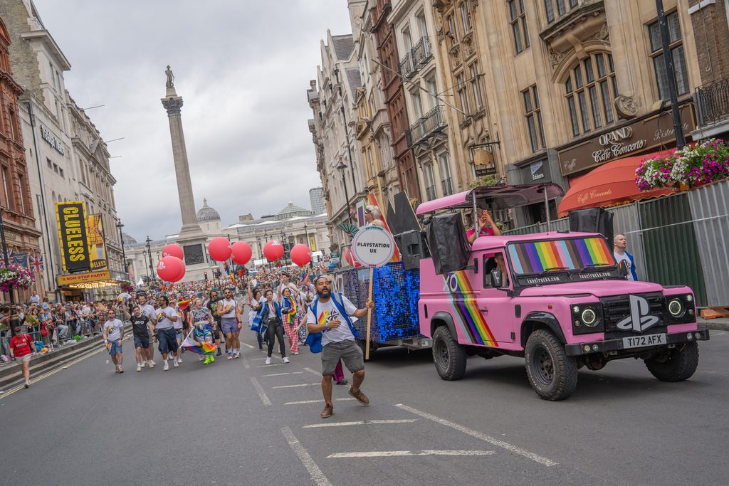 A group photo of London Sony Interactive employees walking at the London Pride parade.